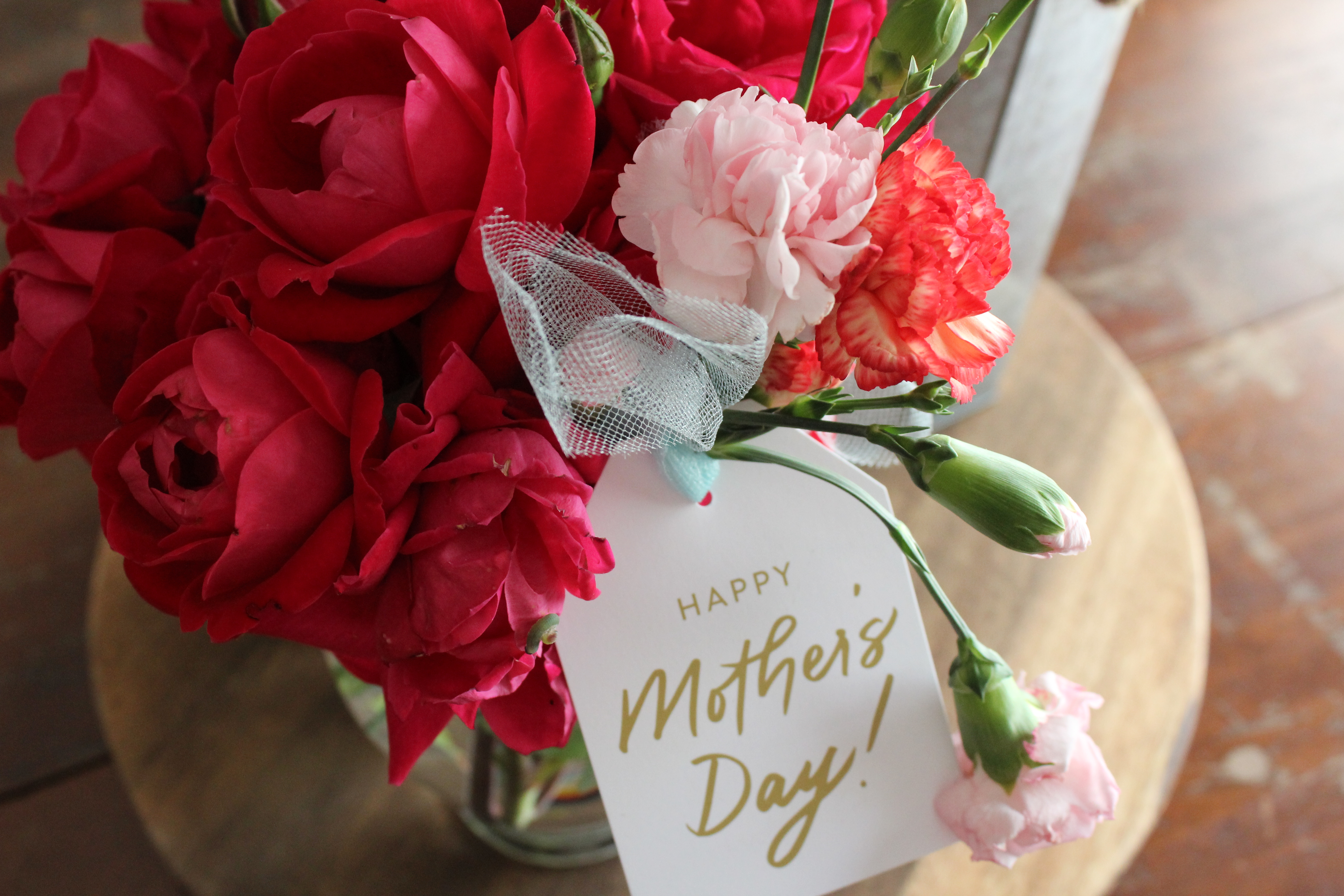 Flowers with a Happy Mother's Day card attached to it.