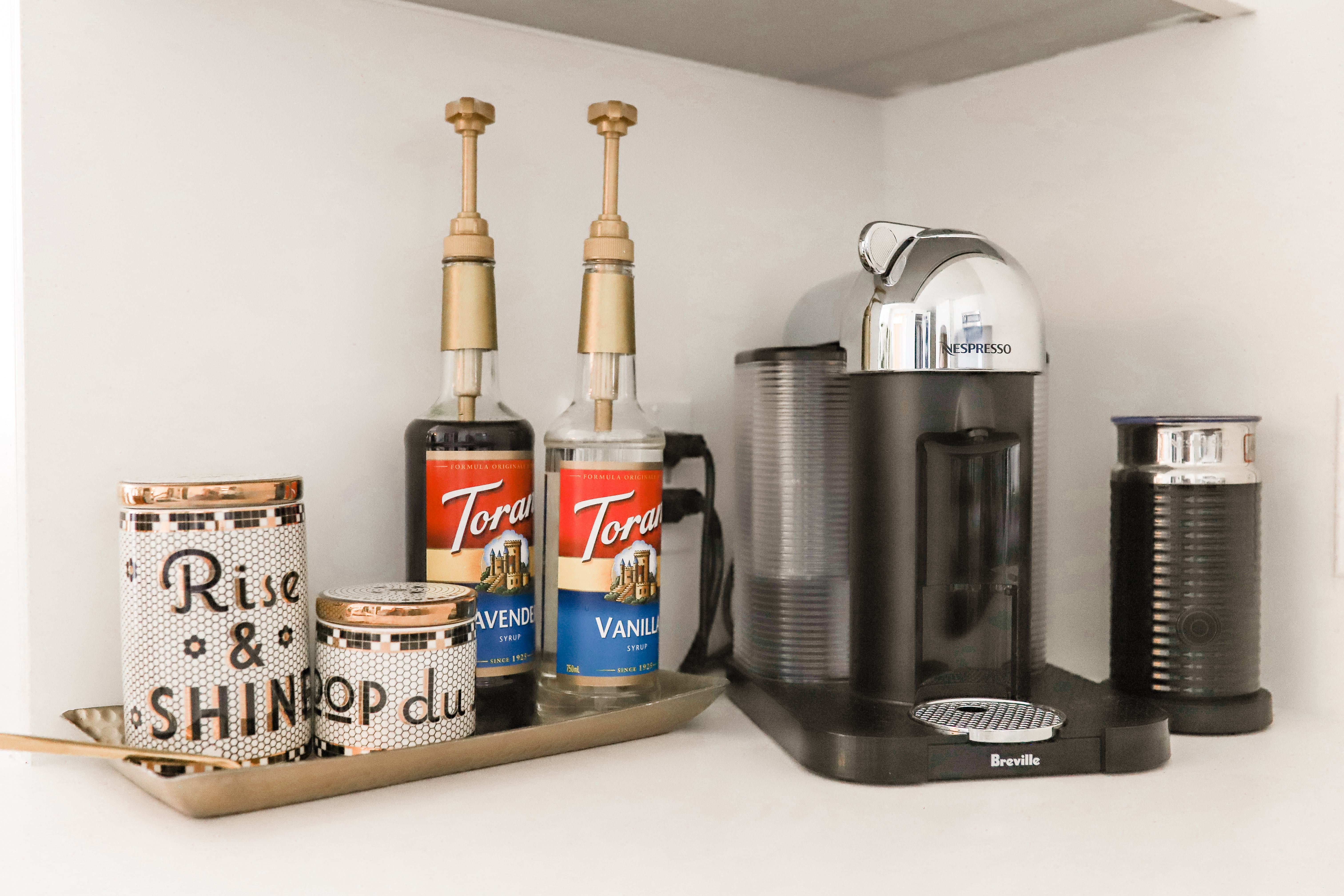 Nespresso machine and coffee syrups.