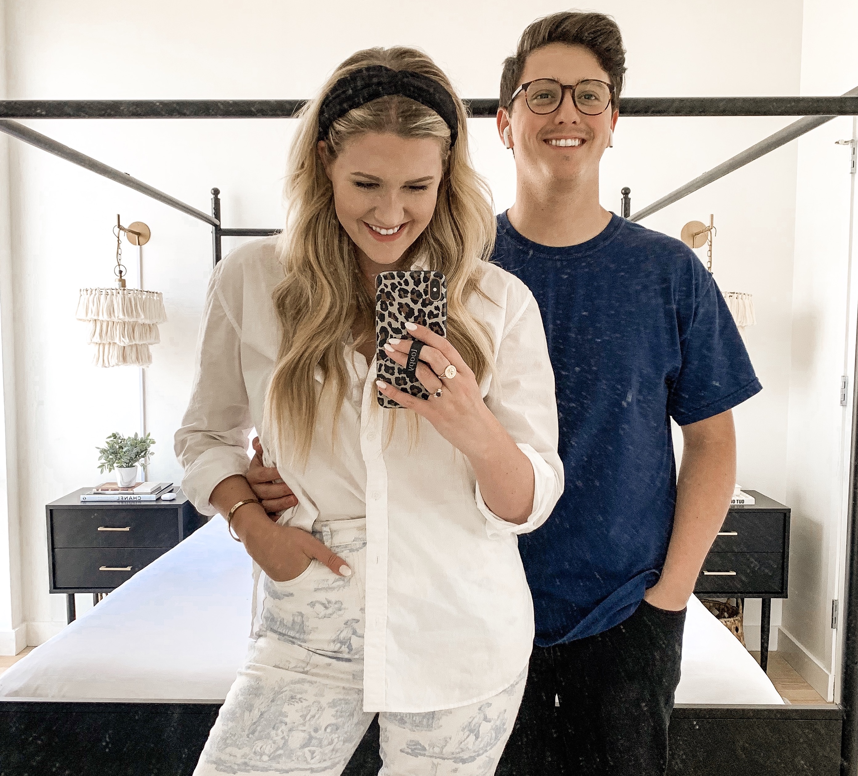 Anna and Nathan standing in their New York City bedroom taking a selfie.