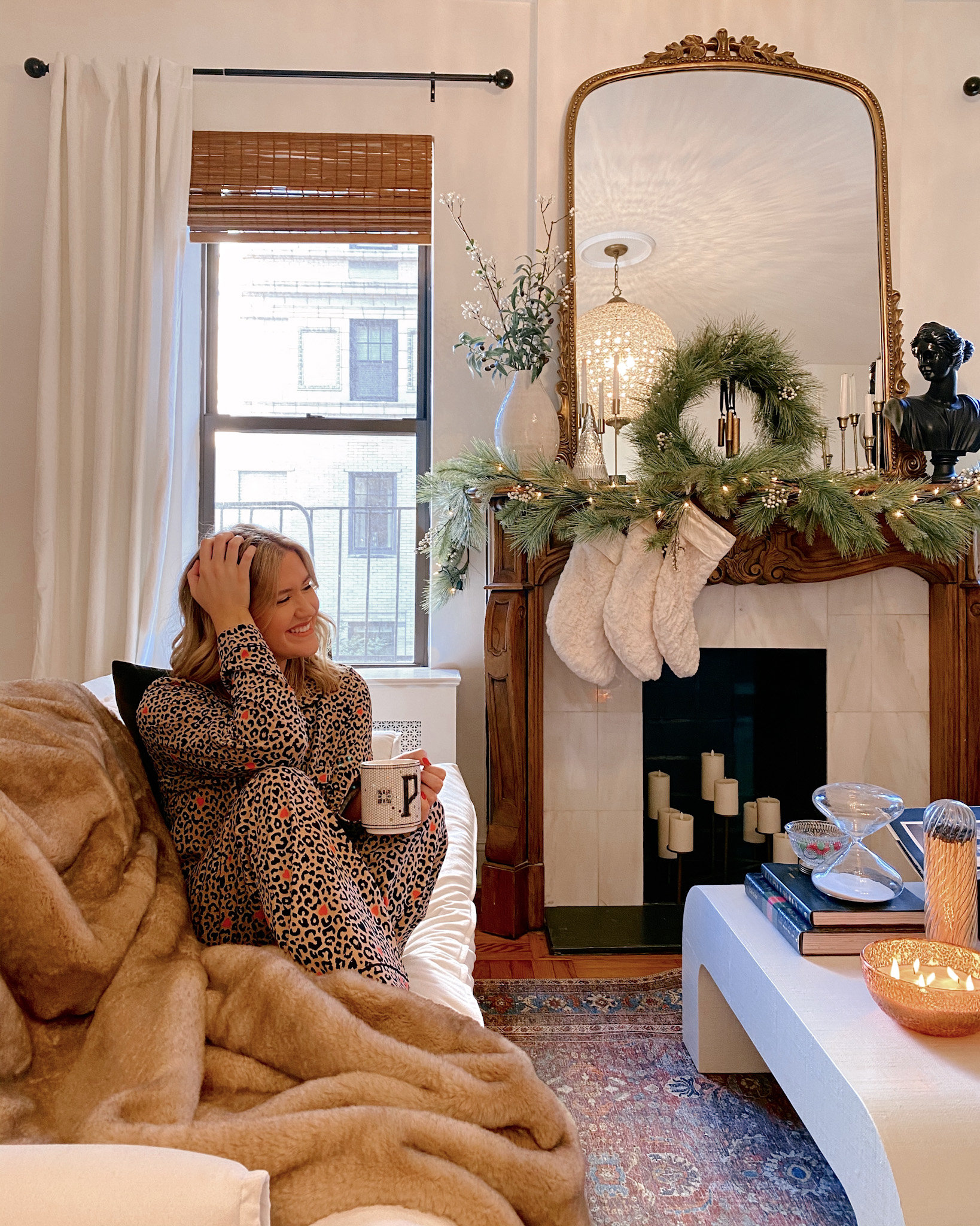 Anna sitting on her couch in her Upper East Side apartment.