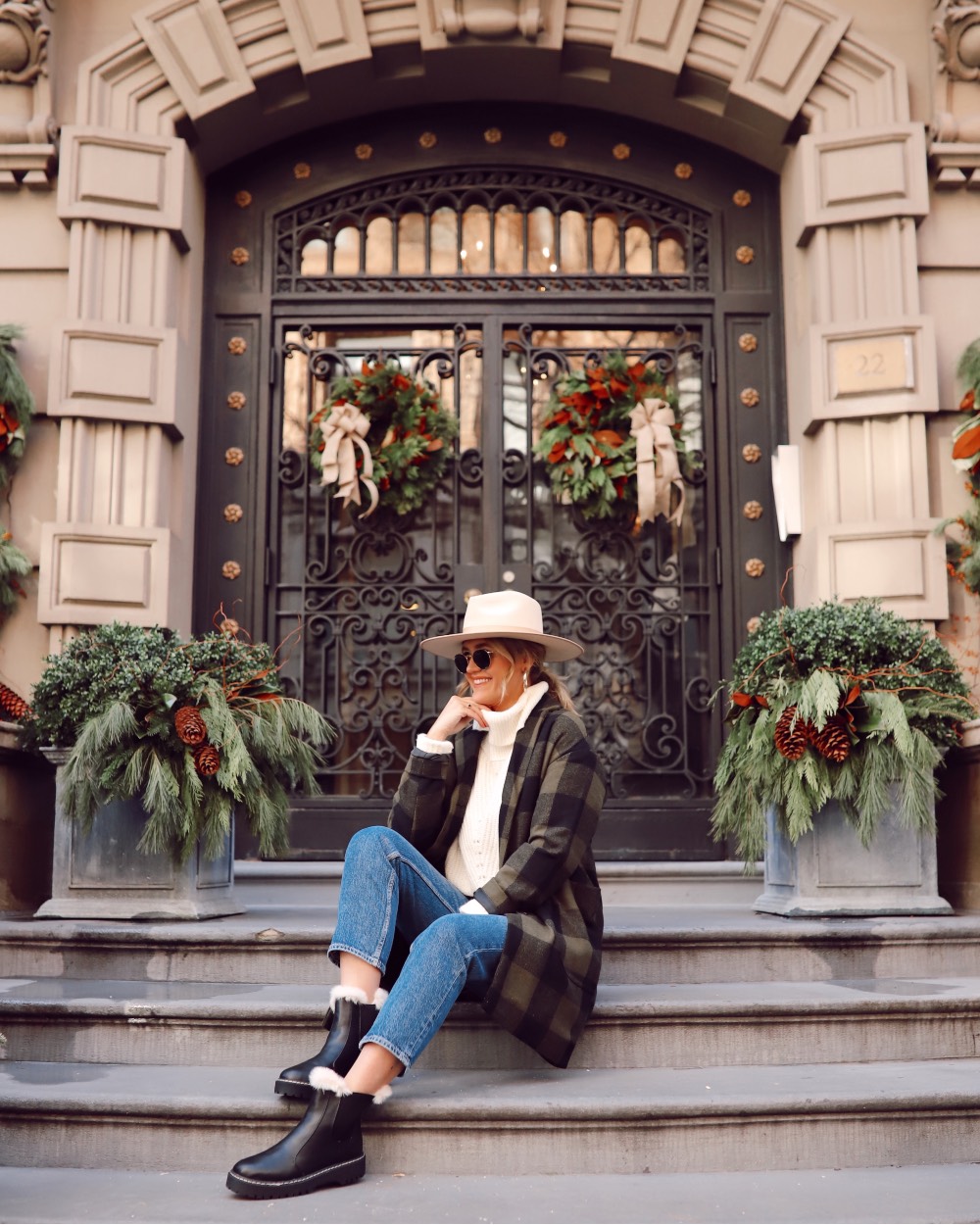 Anna sitting on steps outside a pretty building in New York City.