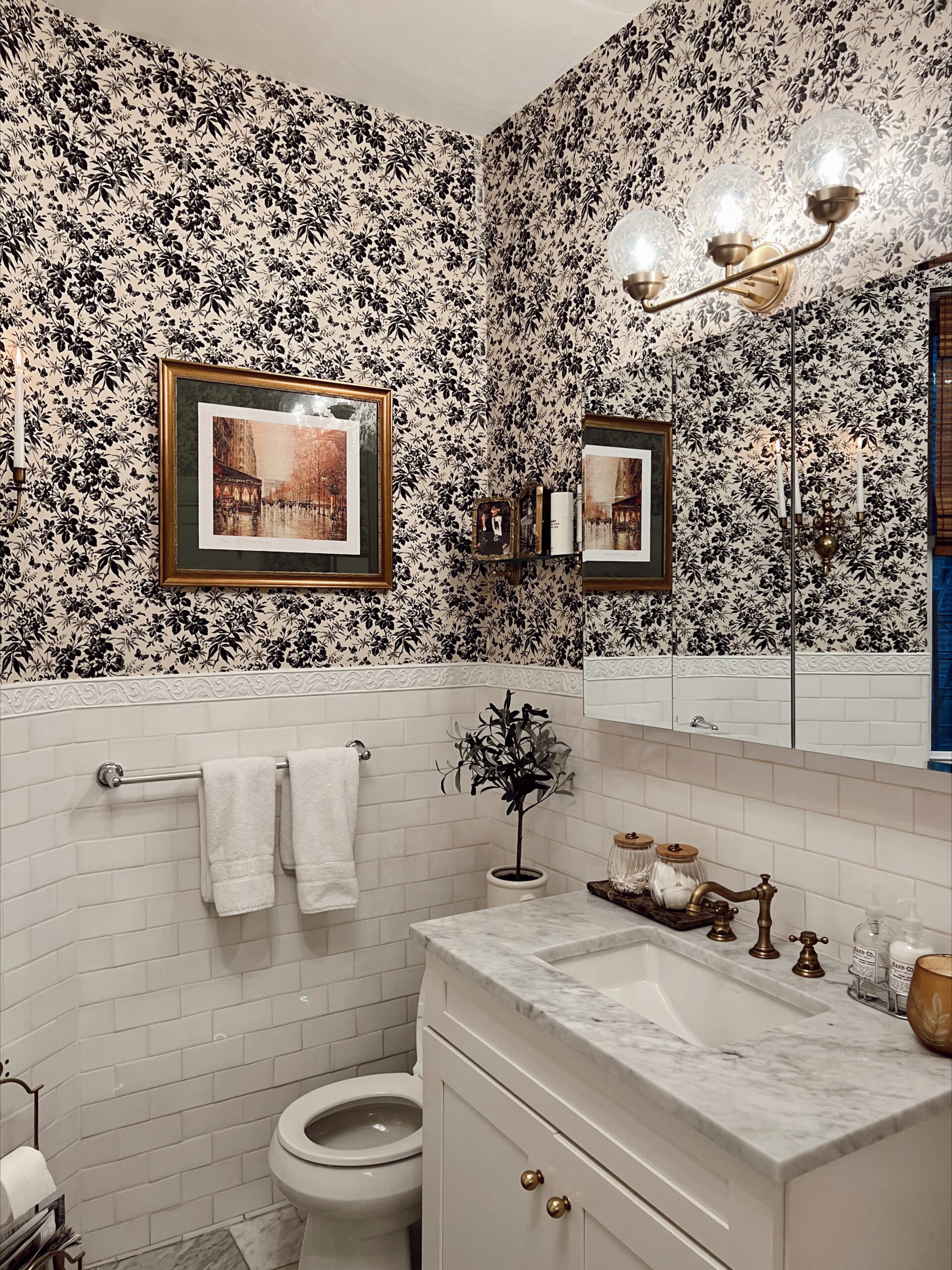 Anna's Upper East Side bathroom with navy blue and white wallpaper.