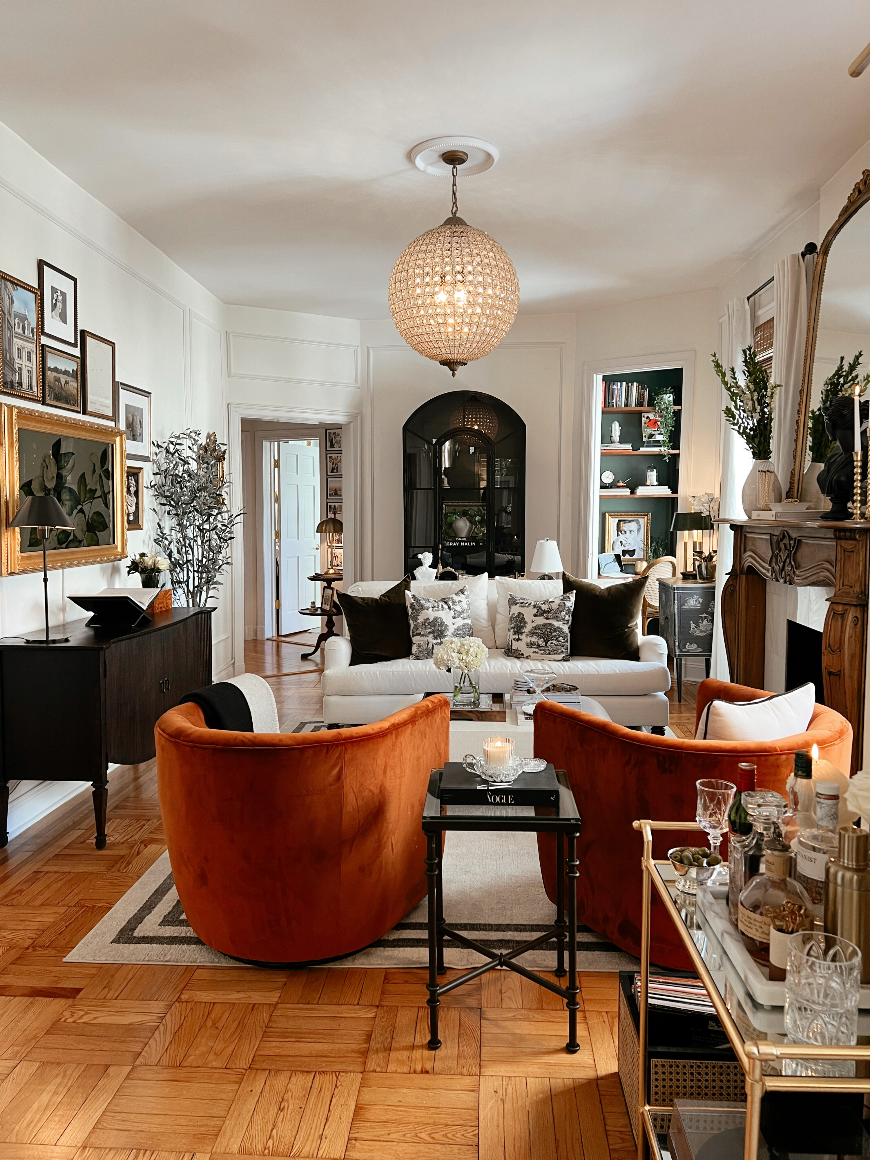 Anna Page's living room with two large orange chairs as the centerpieces of the room.