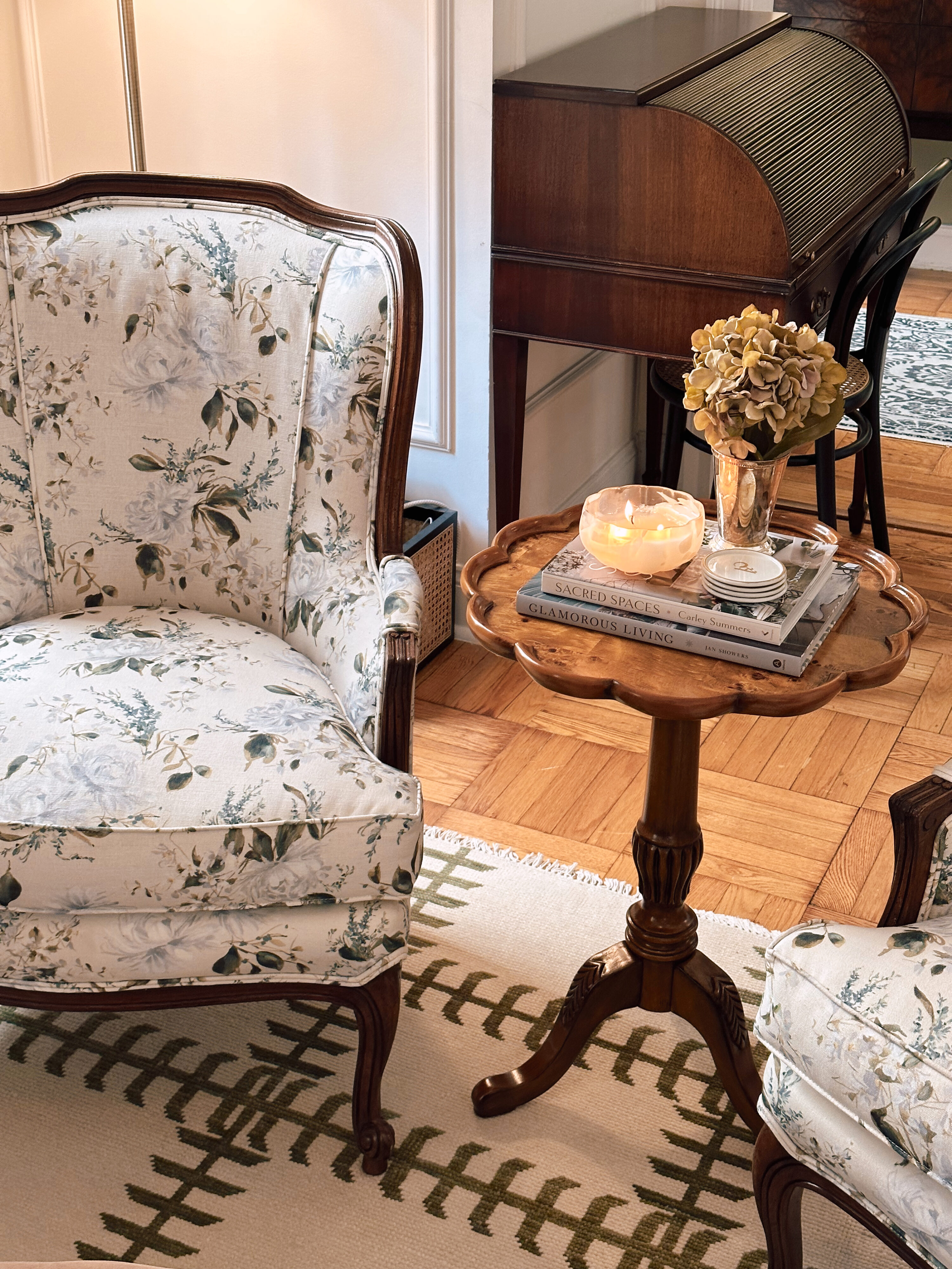 Anna's Upper East Side apartment living room with a chair and small table next to it.